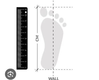 A diagram showing how to measure foot size using a ruler placed vertically against a wall and a foot positioned flat on the ground with the heel touching the wall.